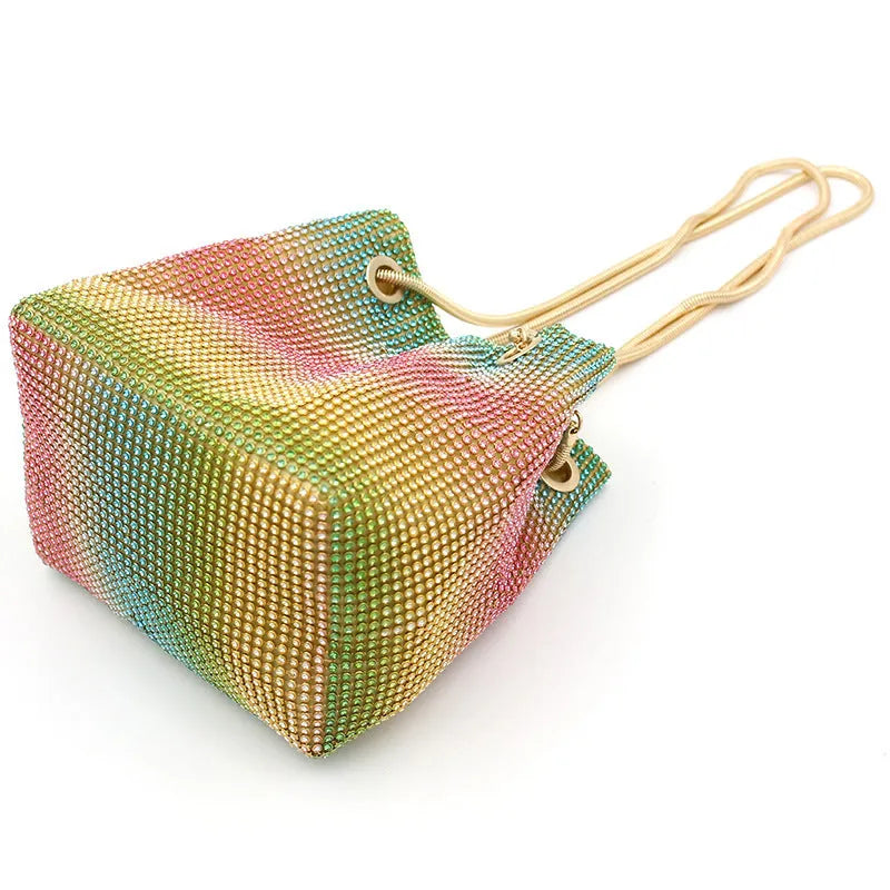 Colourful rainbow glitter rhinestone bucket bag with an adjustable metal chain strap.