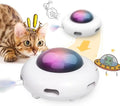 White automatic interactive cat toy with colourful feathers and LED lights on a home floor.