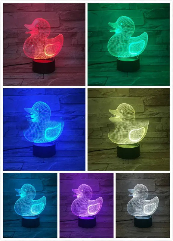 Little yellow duck 3D night light showing colourful LED illumination on a table with remote control.