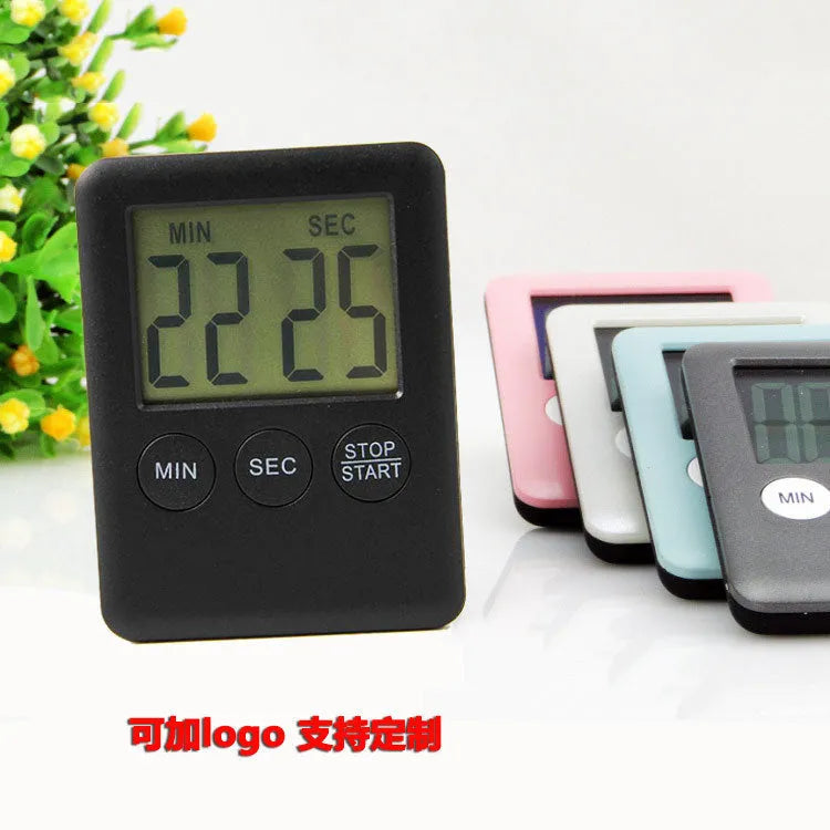 Black and white digital kitchen timer with magnetic back showing countdown display