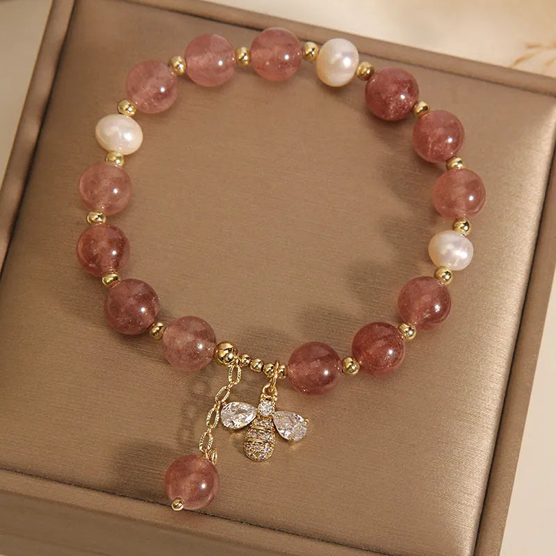 Women's alloy bracelet with three strawberry quartz stones, freshwater pearls, and zircon accents.