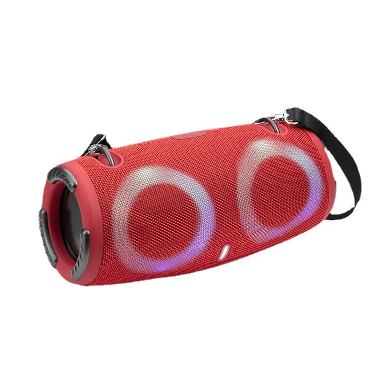 War Drum portable Bluetooth speaker with coloured RGB lights on a table outdoors.