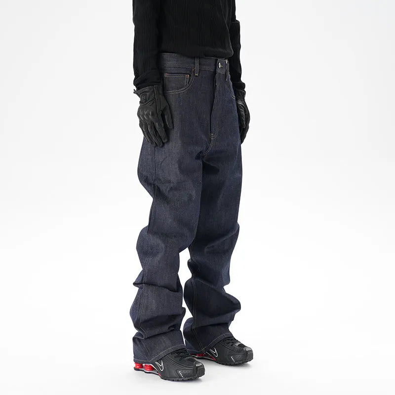 A pair of dark blue loose straight-cut jeans laid flat, showing the front design.
