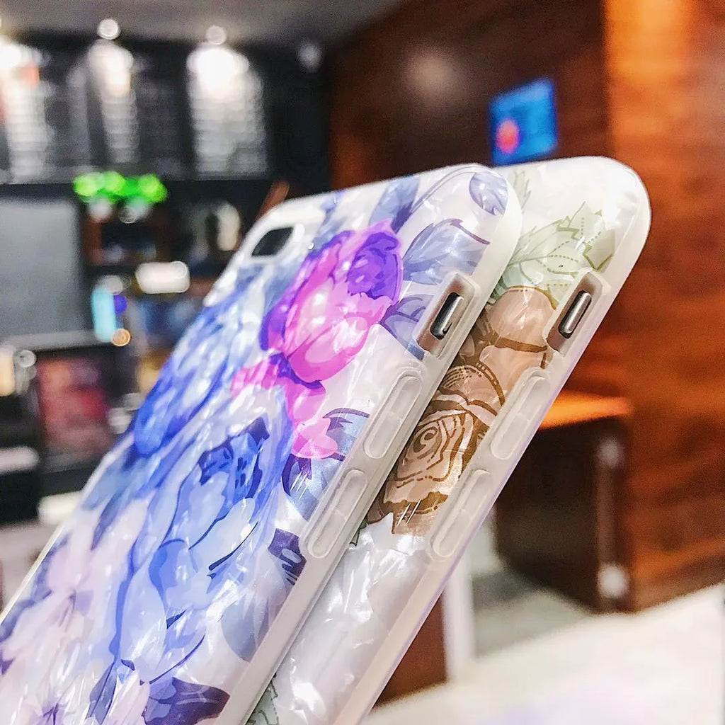 Dream Shell soft TPU iPhone case with rose flower design in brown, shown on an iPhone.