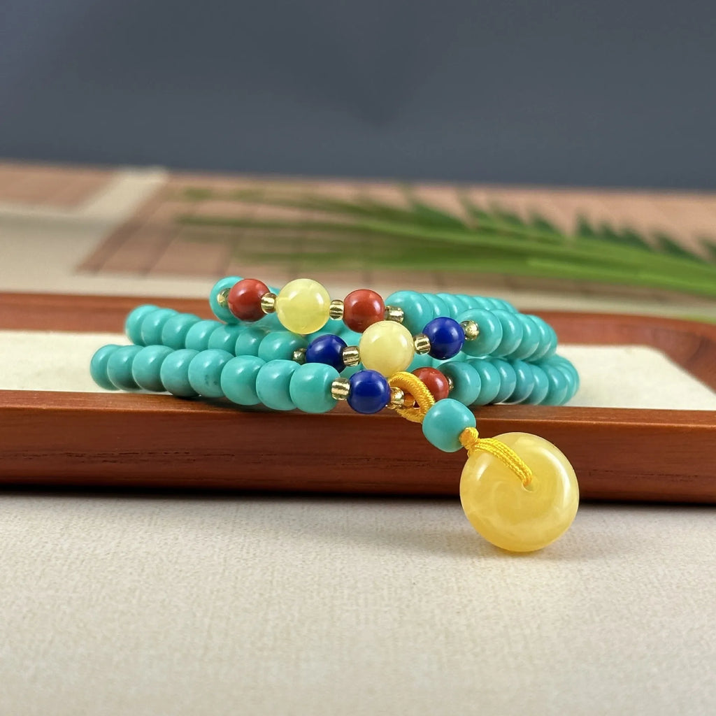 Hand-woven turquoise necklace with a large mesh flower lucky pendant on an adjustable ball bead chain.