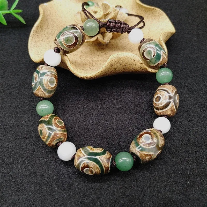 Green agate ethnic bracelet with a large three-eye bead and hand-woven band.