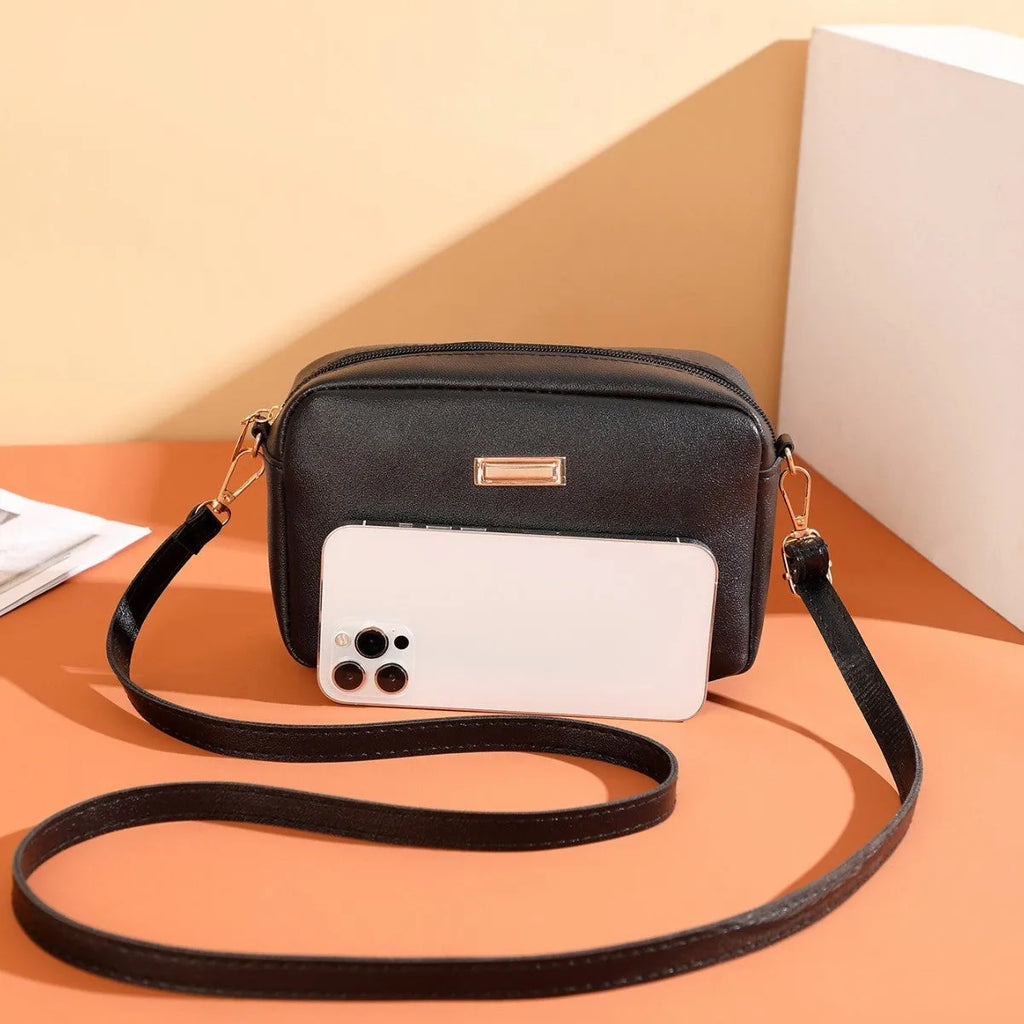 Women's solid colour PU shoulder bag with a horizontal square shape and a front pocket.