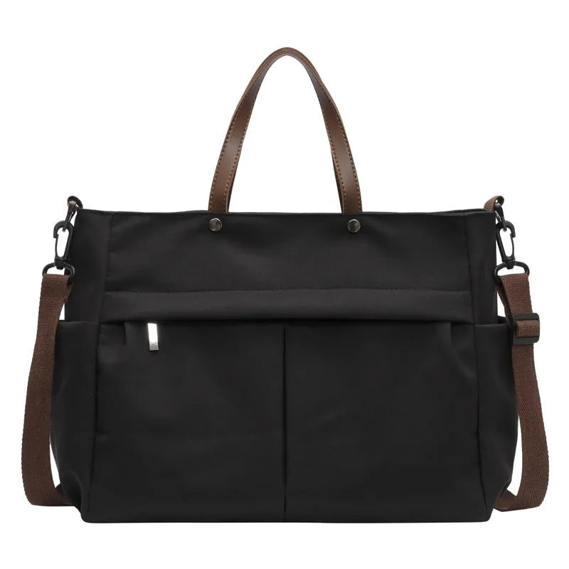 Nylon crossbody bag with adjustable strap in black colour, showing tote design with 39cm length