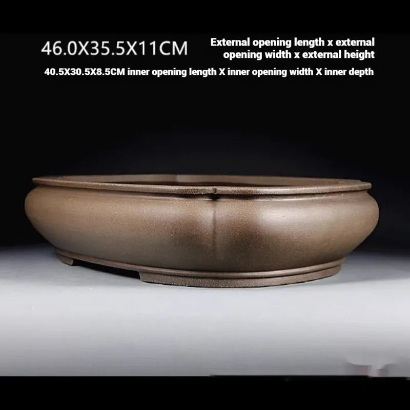 Handmade antique purple clay papaya-shaped flower pot on a table.