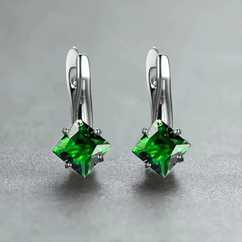 A pair of women's copper earrings with a simple diamond design and inlaid zircon stones, shown in blue.