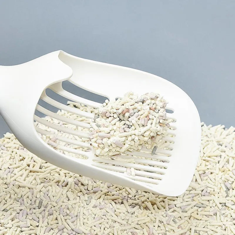White plastic cat litter scoop with attached storage base on a white background.