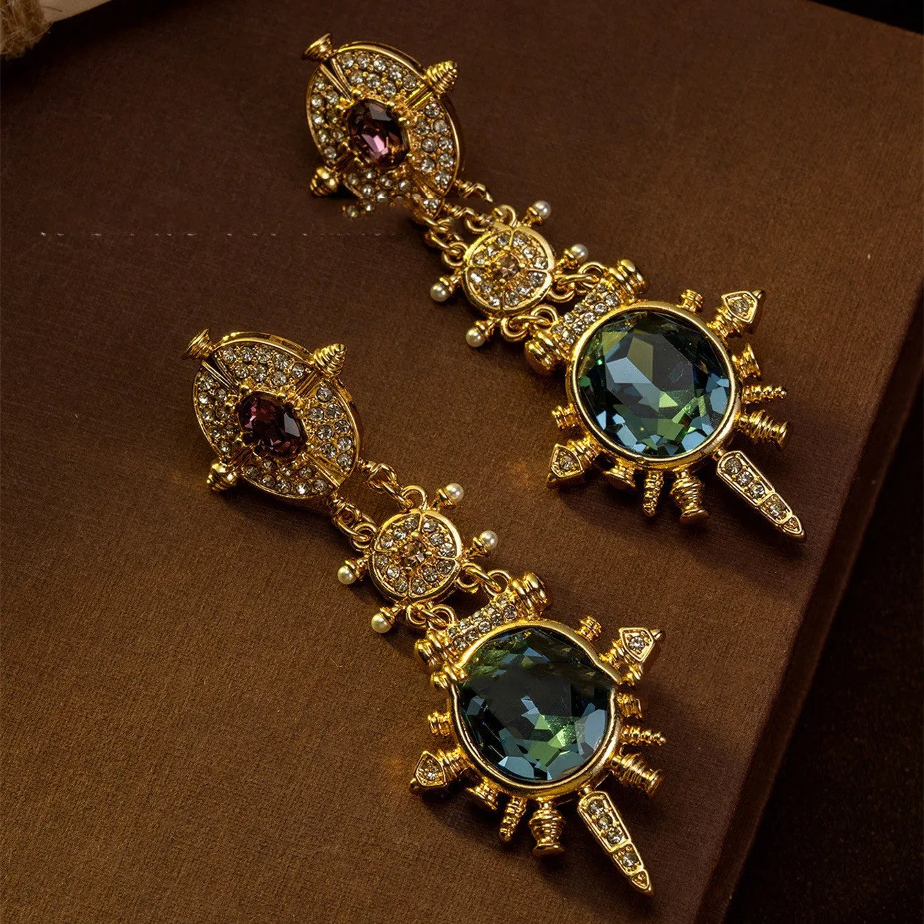 A pair of gold retro-style stud earrings with a geometry shape and round design elements.