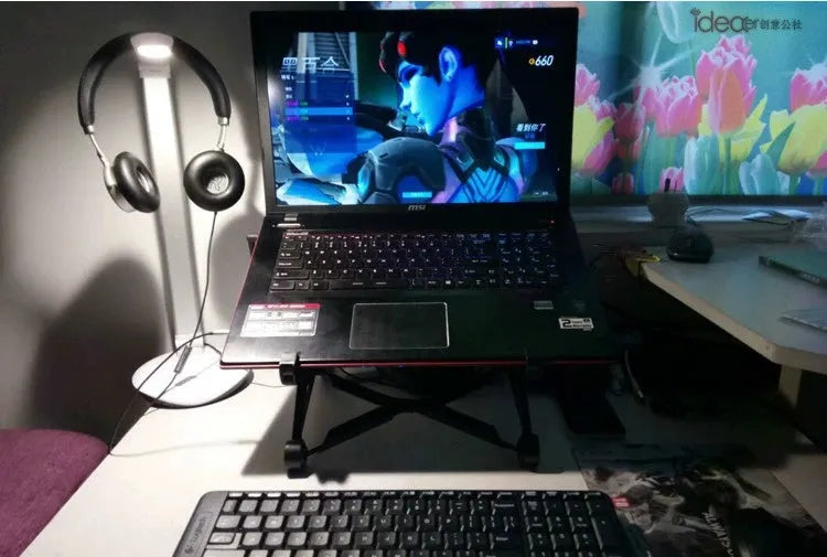 Black foldable laptop stand with height adjustment and protective nylon carrying case