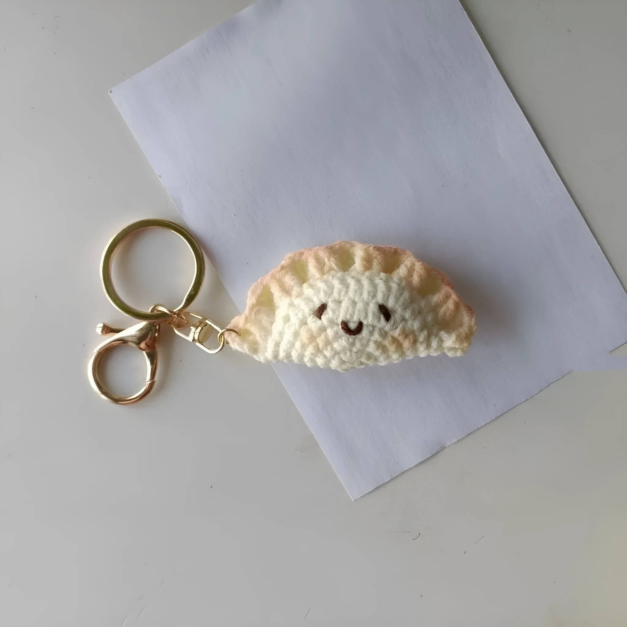 Handmade crochet dumpling pendant with plush material and keychain in traditional dough eye design