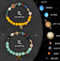 Two natural stone beaded zodiac bracelets with an adjustable closure on a wrist.