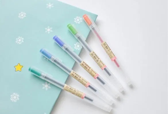 Pack of 12 black Muji gel pens with 0.5mm fine tips on a white background.