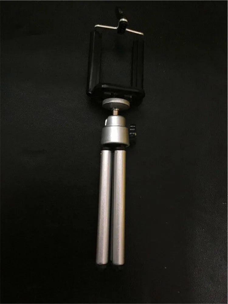 Black adjustable two-section bracket desktop phone holder on a wooden desk.