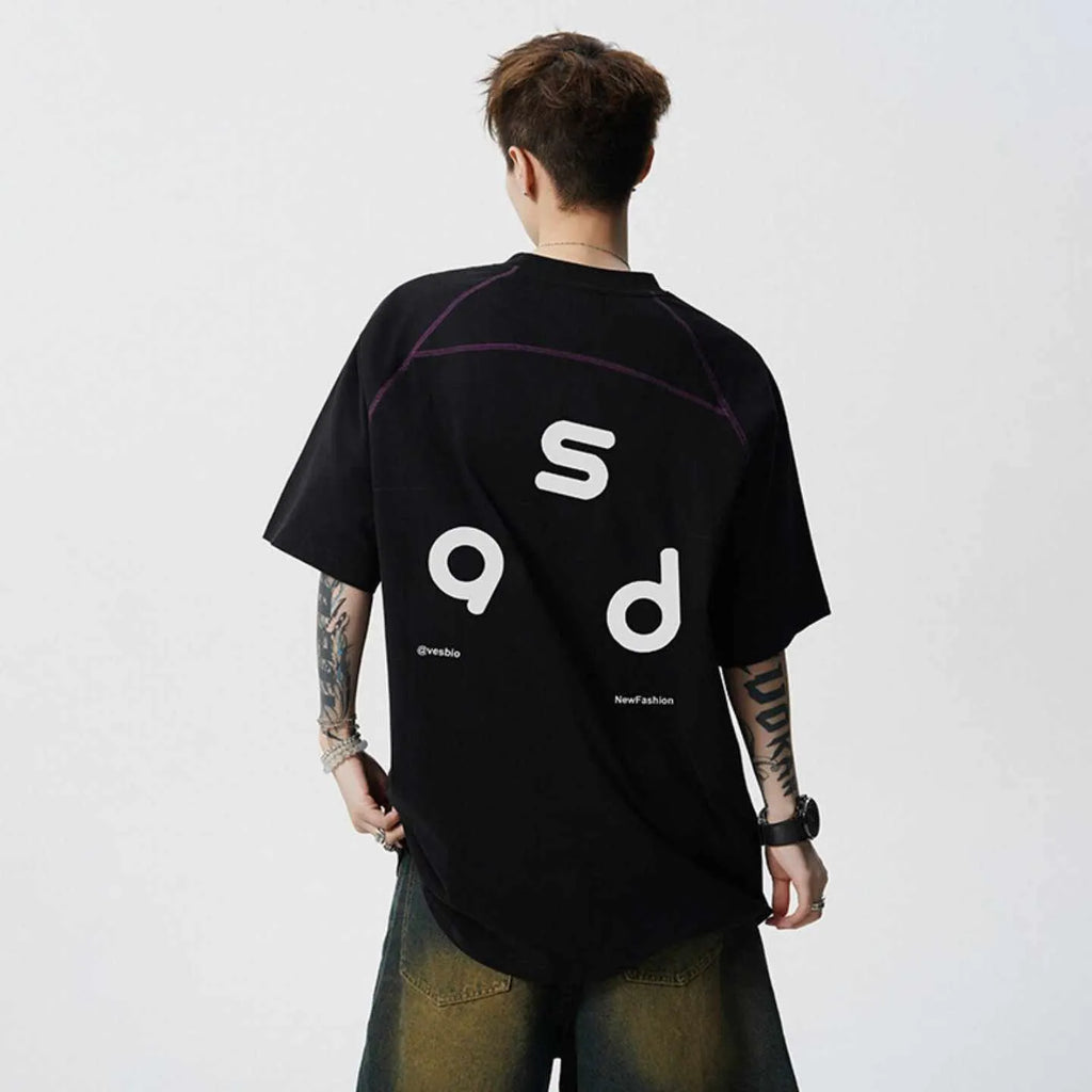 A loose-fit black cotton T-shirt with a white letter print on the front, showing a round neck and short sleeves.