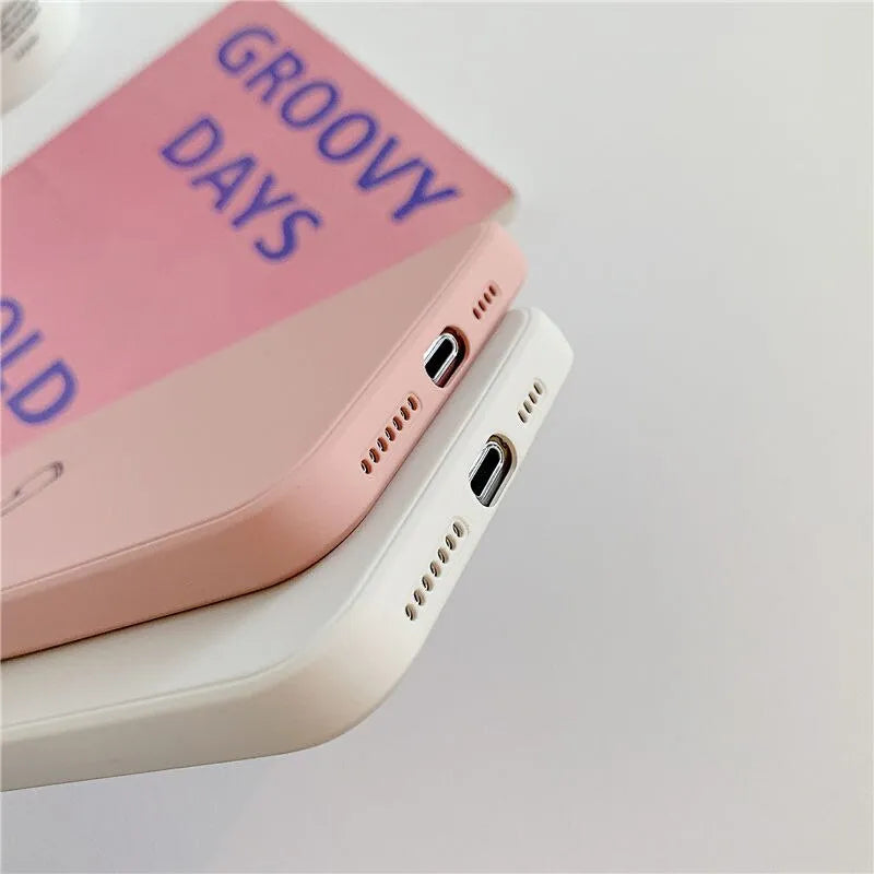 Solid colour silicone phone case for iPhone shown in black, green, grey, light green, pink, purple, red, and white options