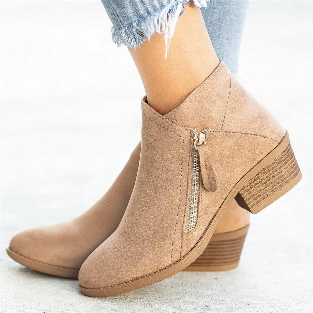 Women's beige suede ankle boot with side zip, lace-up front, and chunky composite sole.
