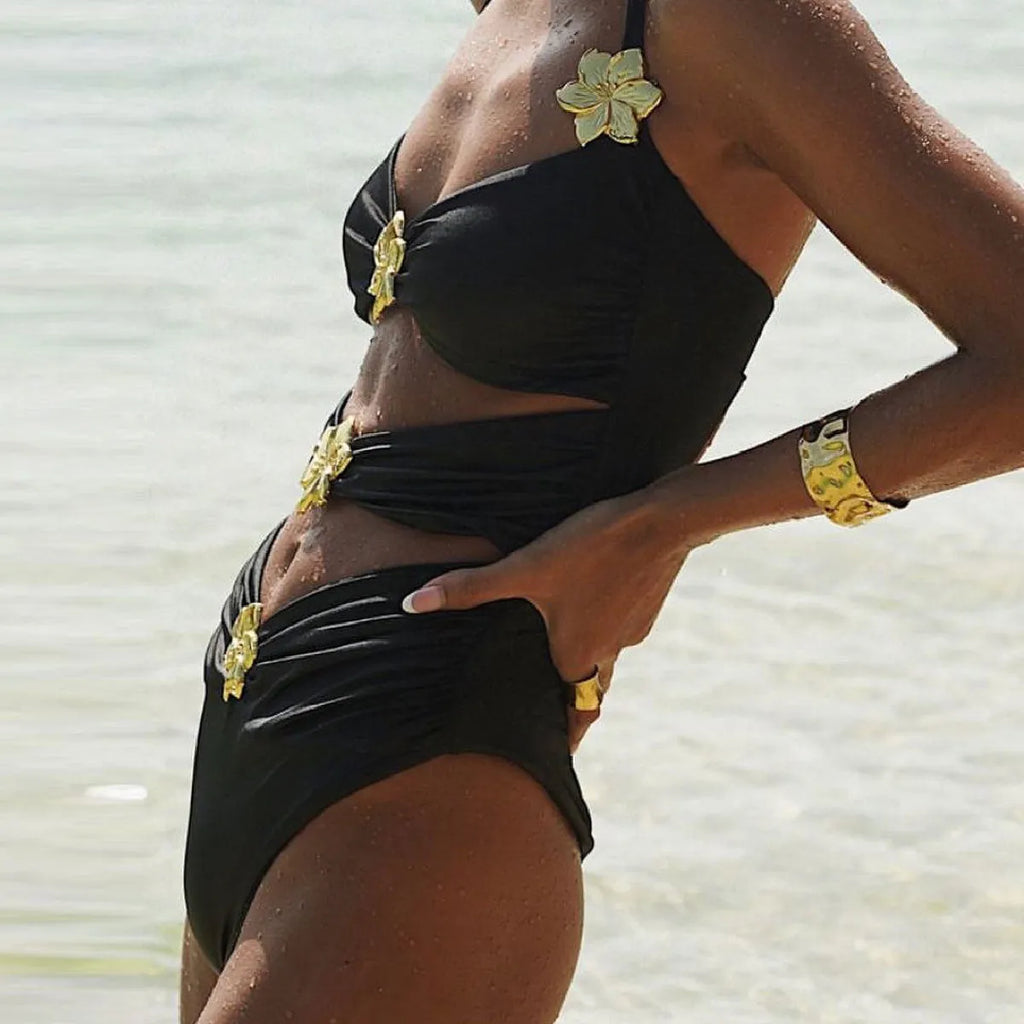 Women's solid colour one-piece swimsuit with hollow out tube top and matching short skirt.