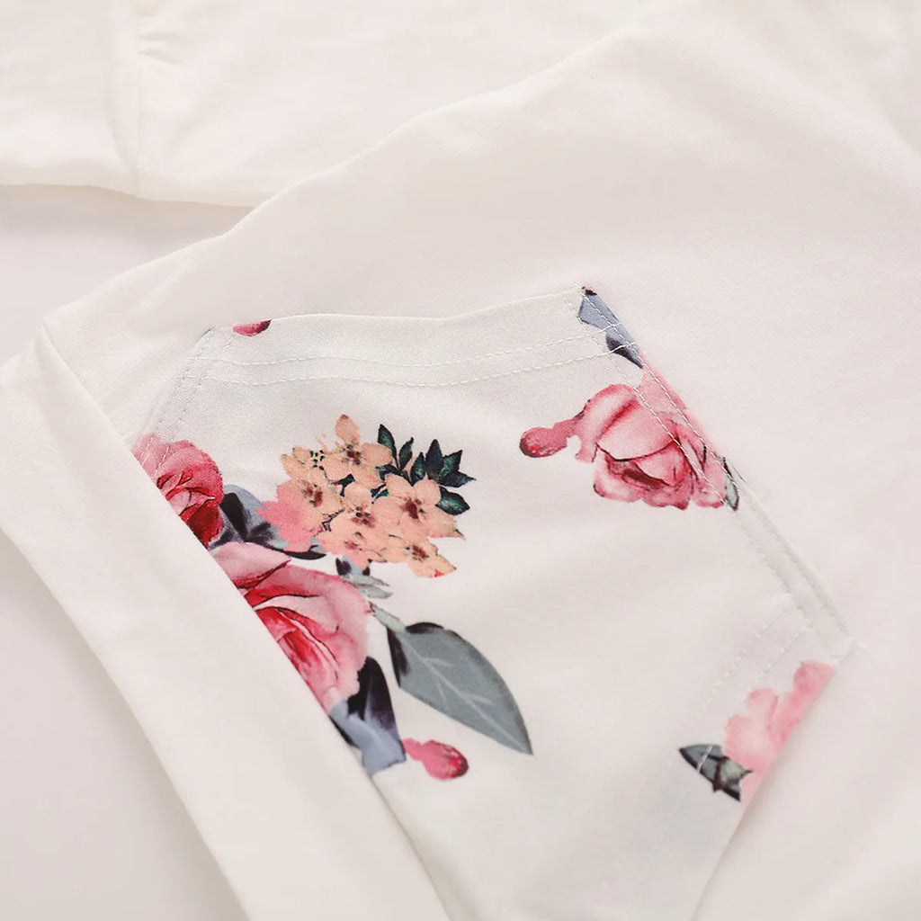 White print hooded romper suit for baby girls made from soft cotton with long sleeves and trousers.