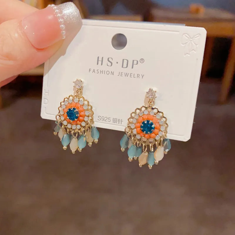 Round crystal tassel earrings with diamond embedded design in thick gold plated copper