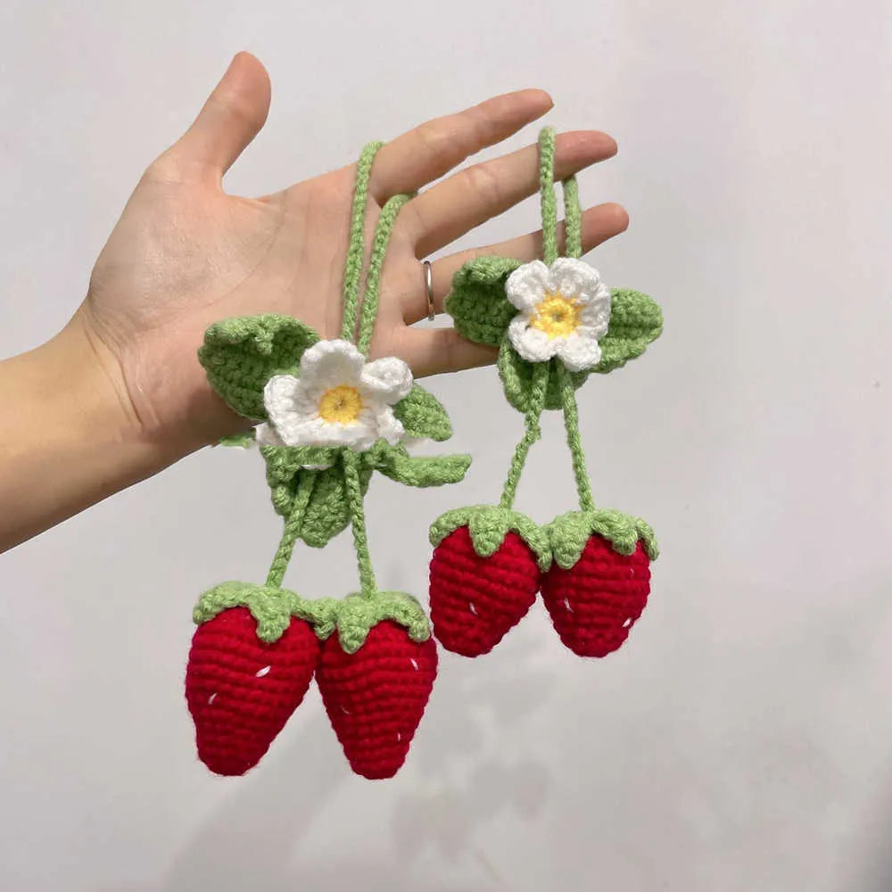 Handmade crochet strawberry-shaped car pendant made from cotton and hemp yarn.
