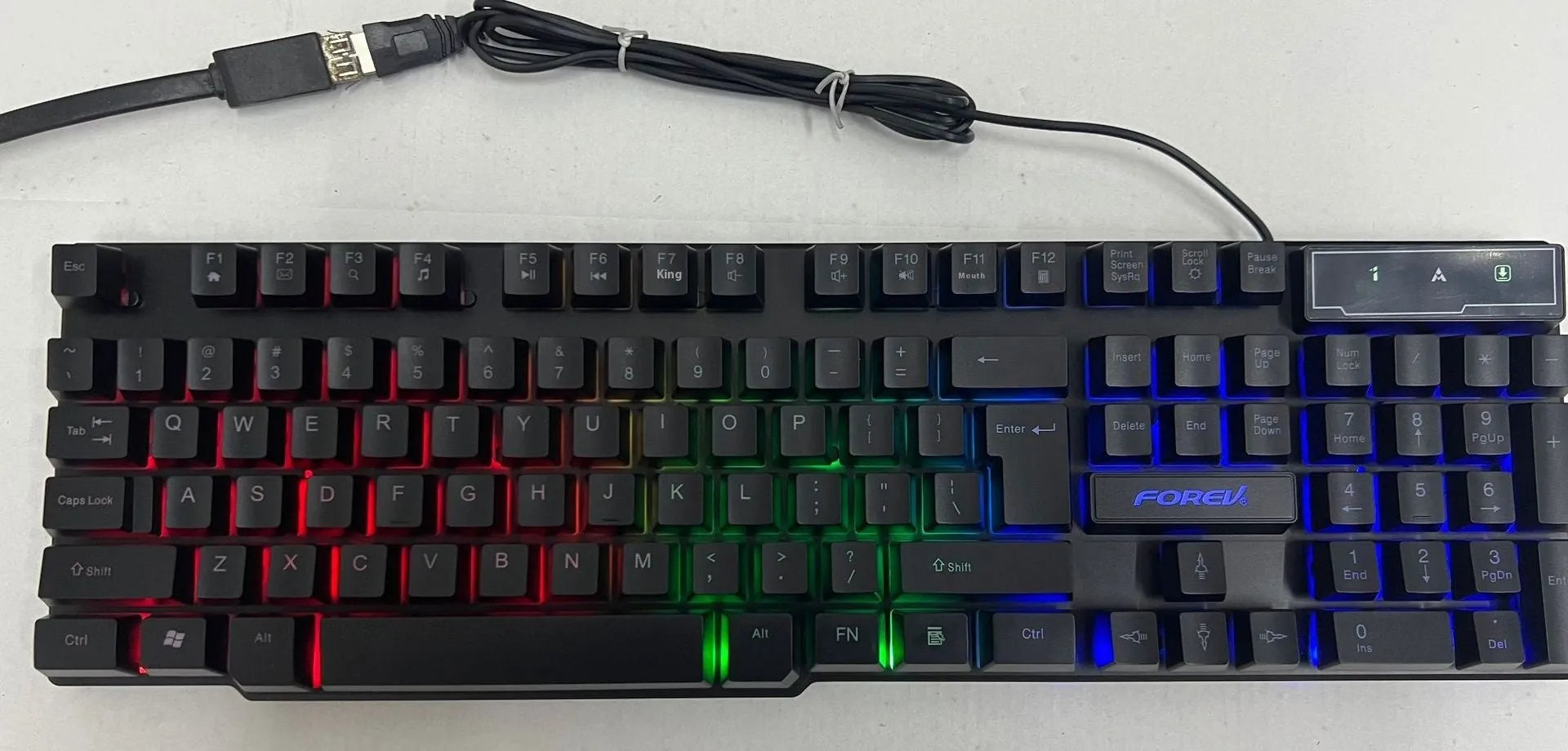 FV-Q1 wired luminous keyboard with six-colour backlight on a desk, connected to a computer