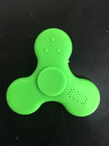A square blue Bluetooth speaker and MP3 player with an integrated fidget spinner, showing button controls.