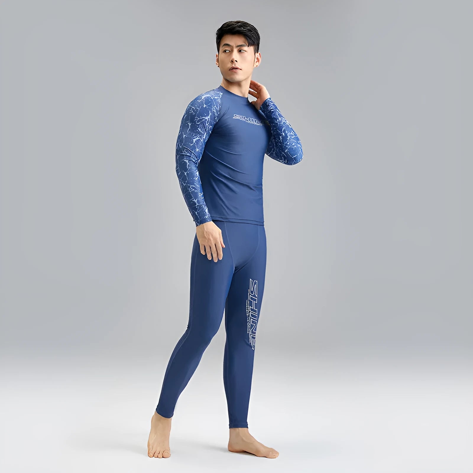 Men's dark blue nylon swimwear set with pattern detail showing swim top and trunks