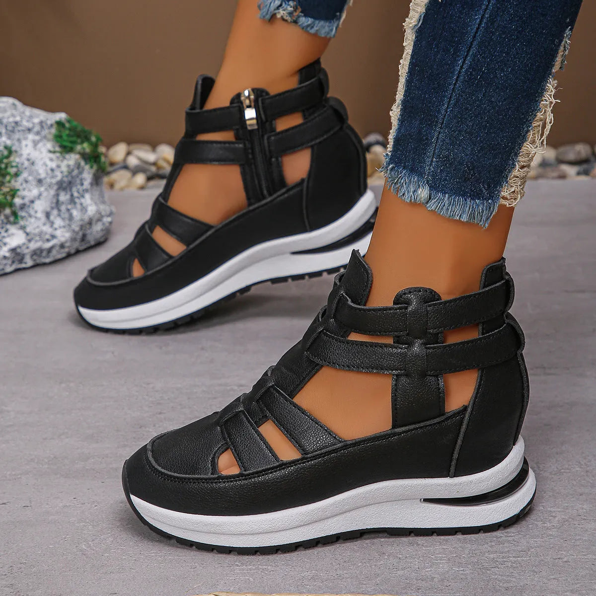 Black women's close-toed hollow-out platform sandals with Velcro strap on a white background