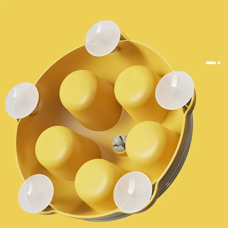 Yellow plastic cat feeding plate with maze design and obstacle ridges for slow feeding