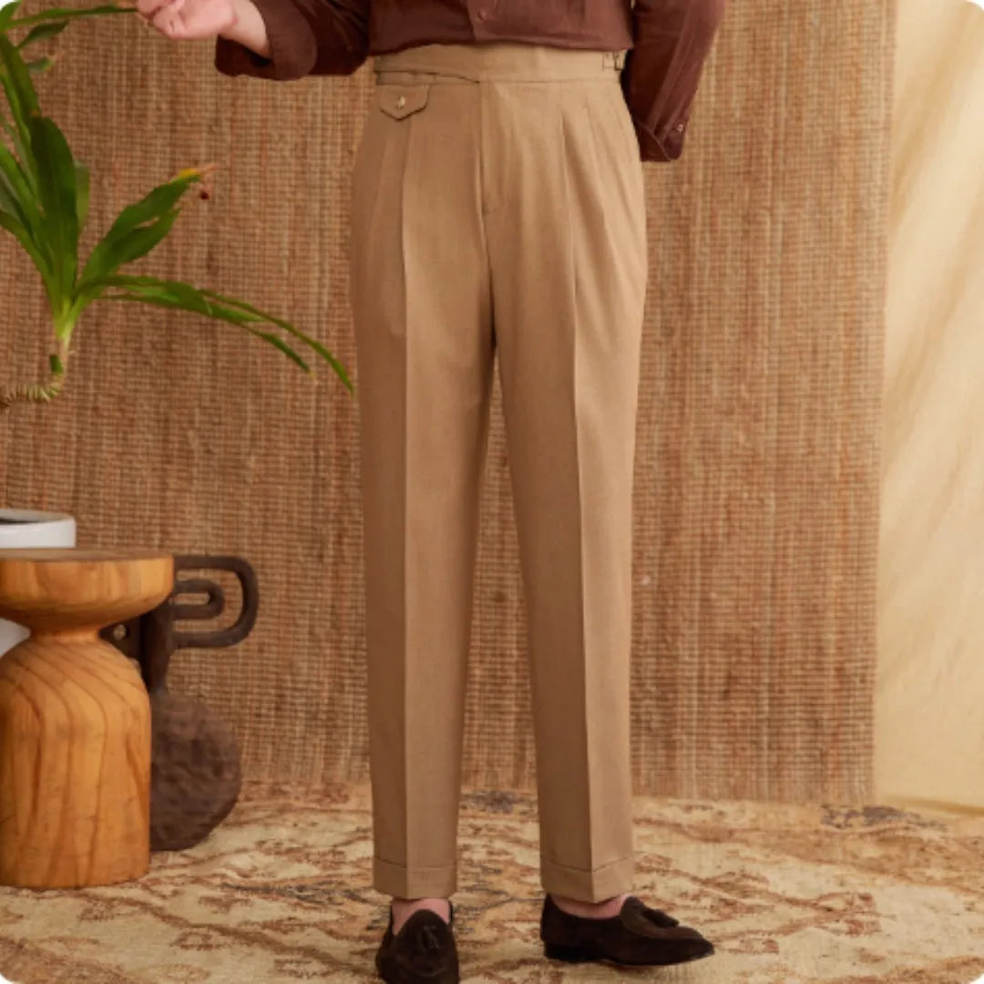 Men's slim fit straight leg trousers in dark grey, light brown, and light apricot colours on a hanger.