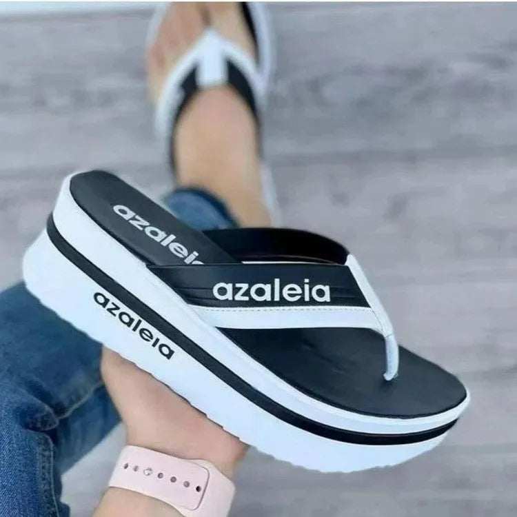 Women's solid colour platform slippers with herringbone toe holder in black, green, and champagne.