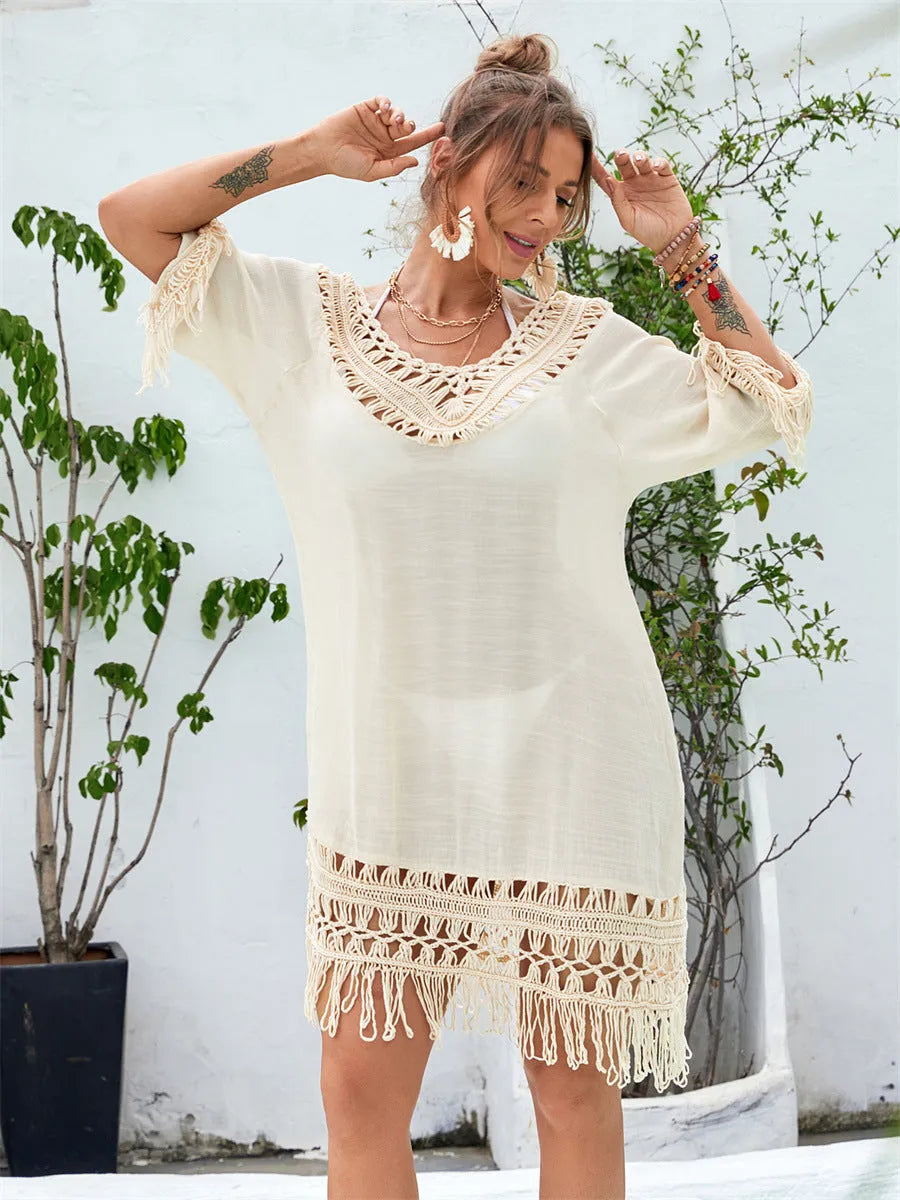 Apricot coloured hand-crocheted women's long beach dress with a lining, shown on a model.