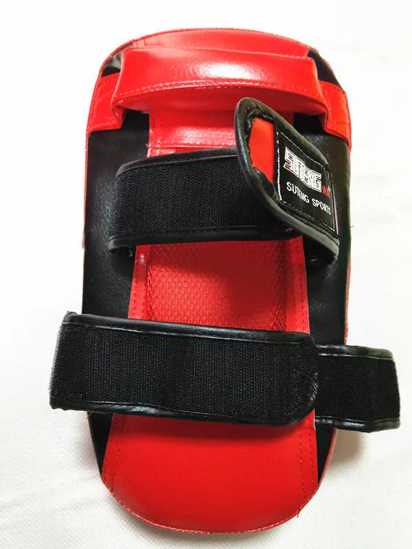 Black and red square hand-held martial arts training target with a double buckle.