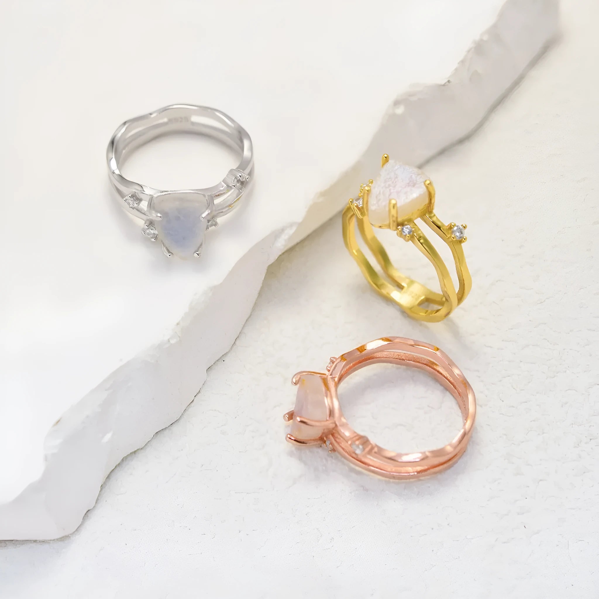S925 sterling silver ring with irregular triangle shape, moonstone, and electroplated rose gold finish.