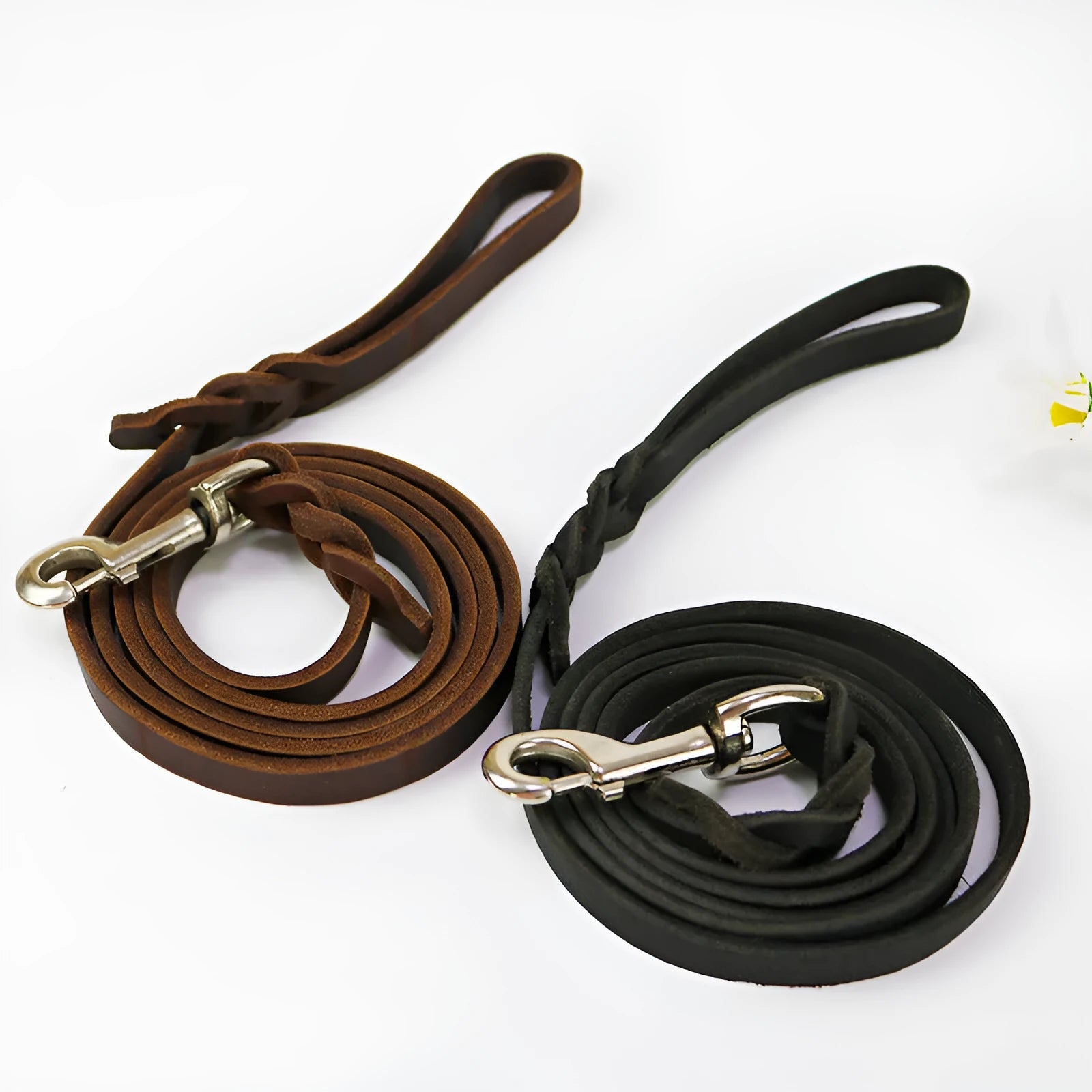 Thickened brown cowhide dog walking rope held in a hand, showing its length and simple strip design.
