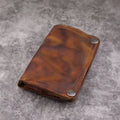 Men's brown leather bifold wallet open showing multiple card slots and coin pocket