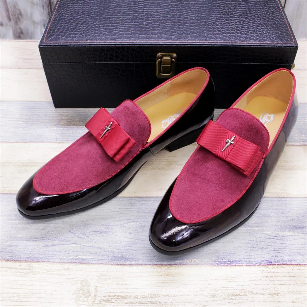 Men's glossy black patent leather low-top shoes featuring a gold tassel detail on a white background.