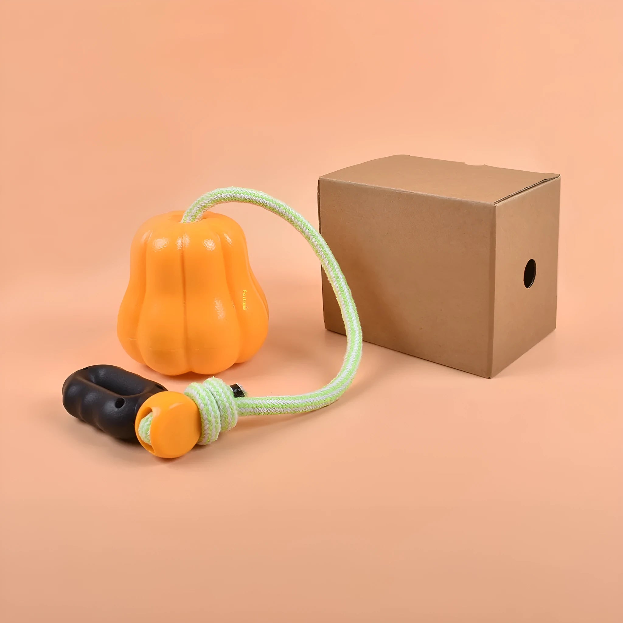 Orange pumpkin-shaped plastic dog ball with a blue rope handle for fetch and tug
