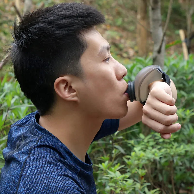 Orange wrist water bottle with Velcro strap showing 200ml capacity and bite valve mouthpiece