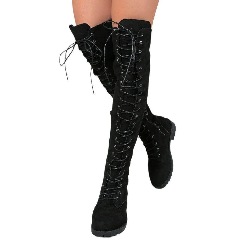 Black lace-up over-the-knee boots with a round head and flat rubber sole on a neutral background.