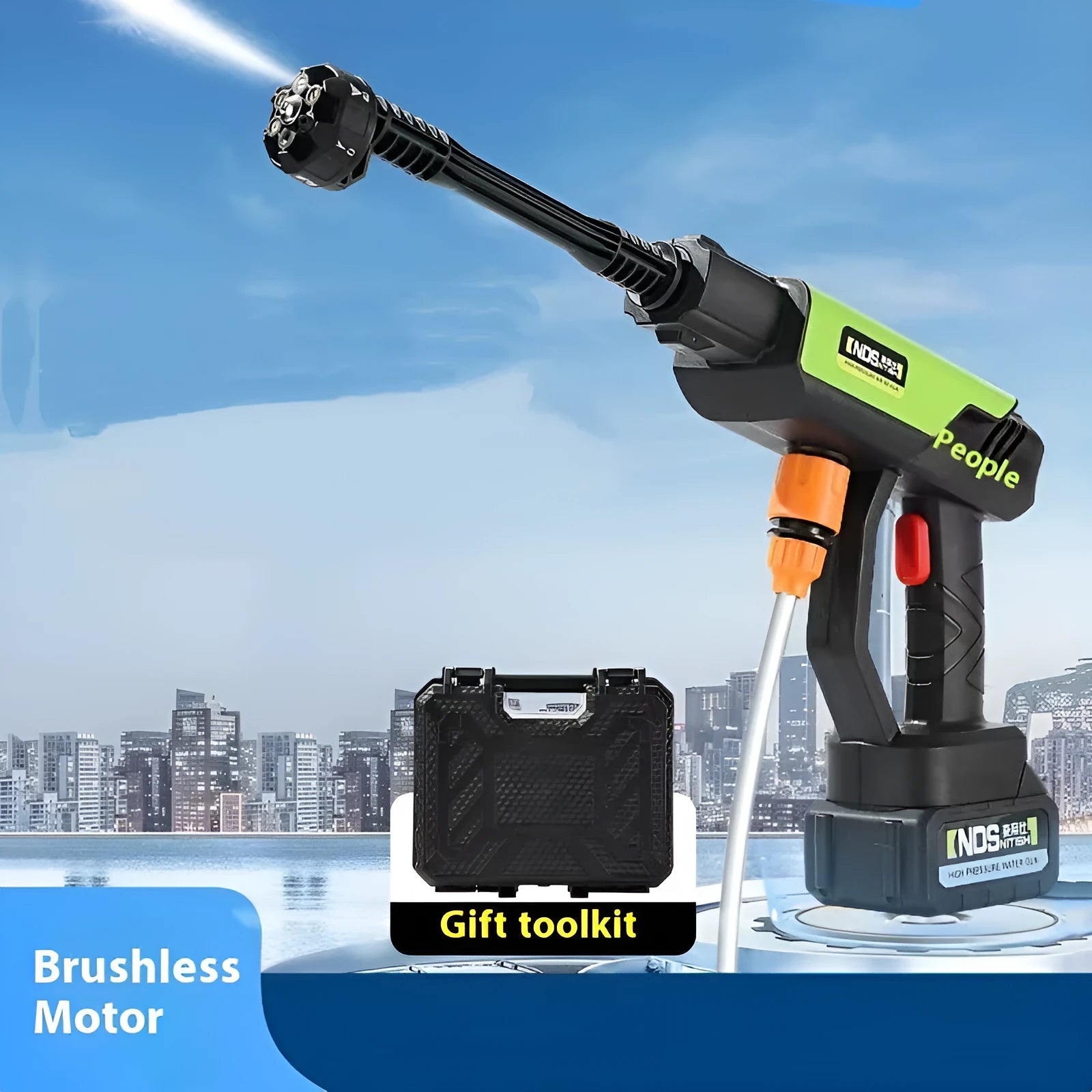 Green wireless high-pressure water gun with metal nozzle and accessories on a table.