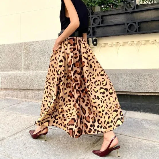 Women's long brown leopard print A-line skirt with a big hem.