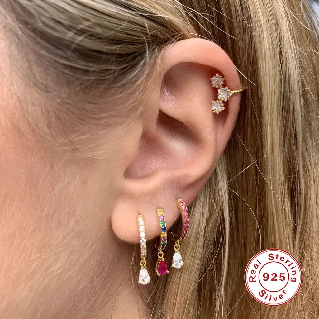 Geometric water drop sterling silver earring with a crystal stone in a gold tone setting.