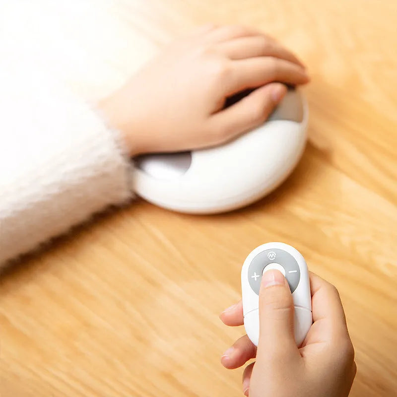 Smart electric hand massager with heat compress in pink and white on desk