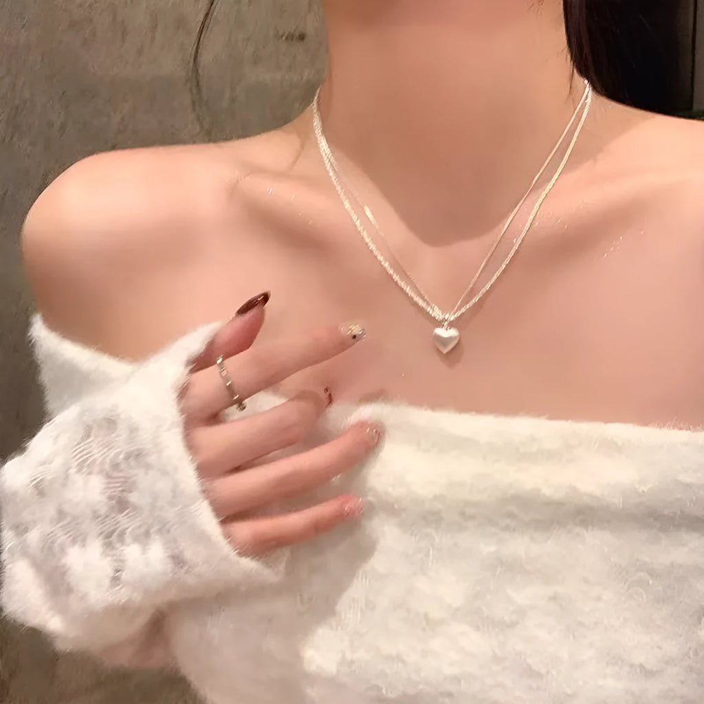 Women's brushed heart-shaped double-layer pendant necklace with adjustable chain on white background