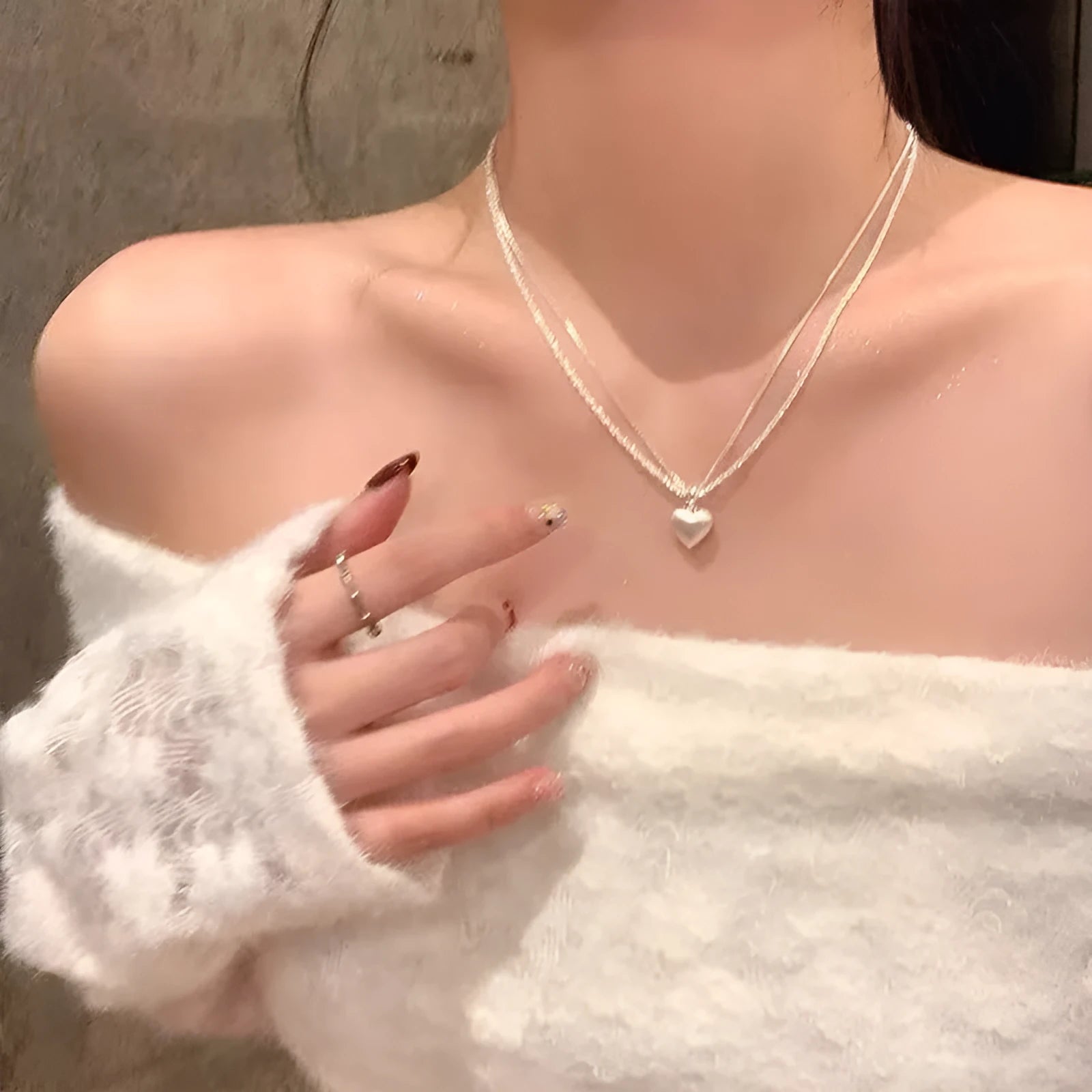 Women's brushed heart-shaped double-layer pendant necklace with adjustable chain on white background